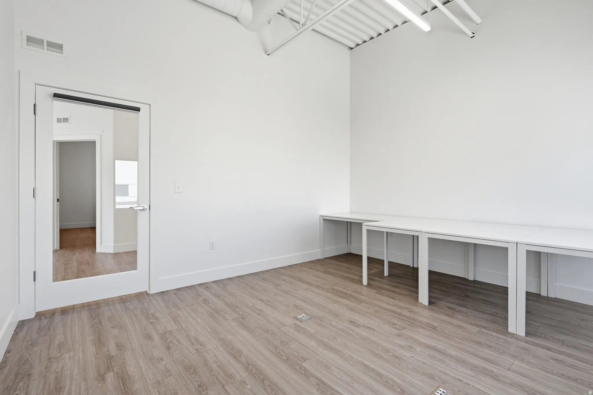 Unfurnished office with light wood finished floors and baseboards