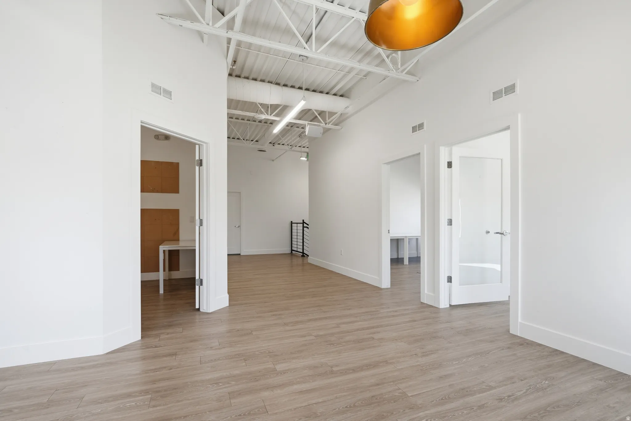 Unfurnished room featuring a high ceiling and light wood finished floors