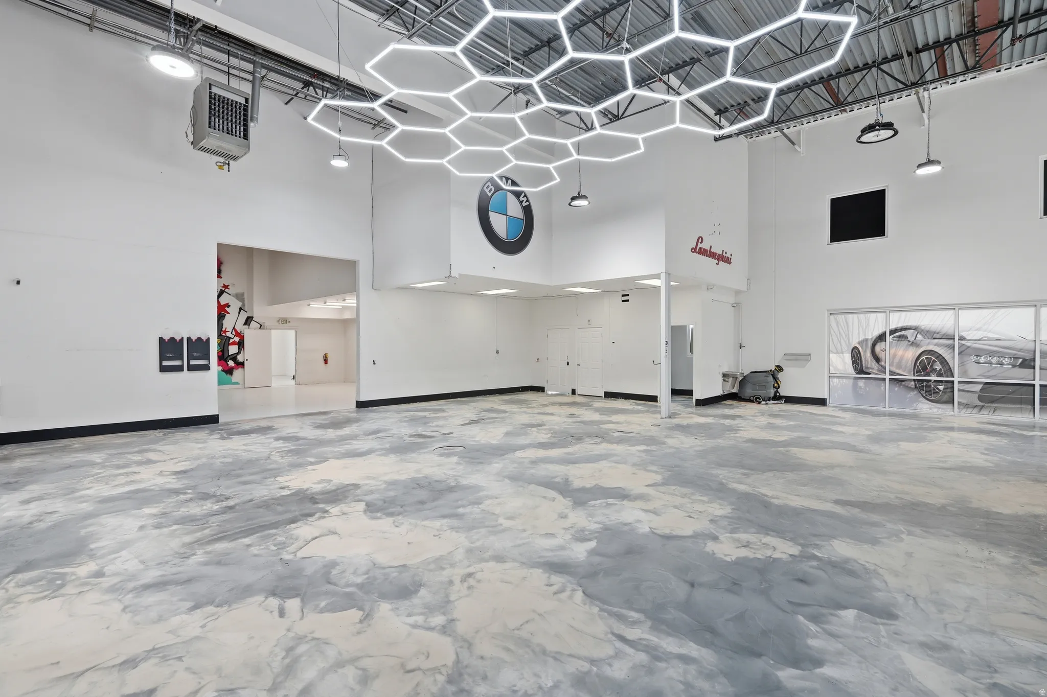 Misc room featuring a high ceiling, a heating unit, and a garage