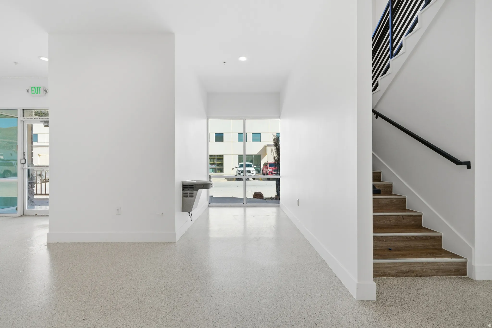 Stairs with baseboards and speckled floor