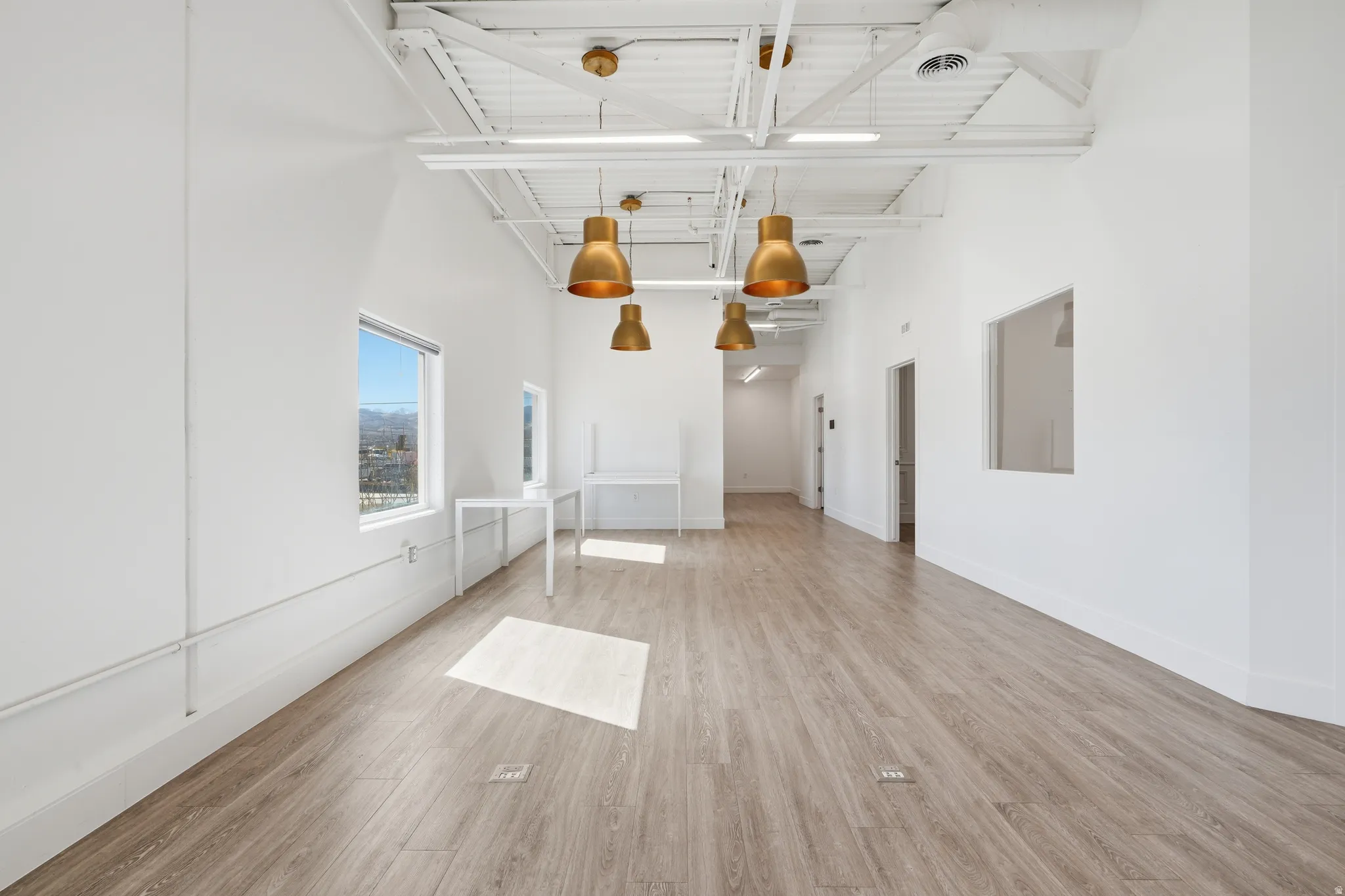Spare room with a high ceiling and light wood-style flooring