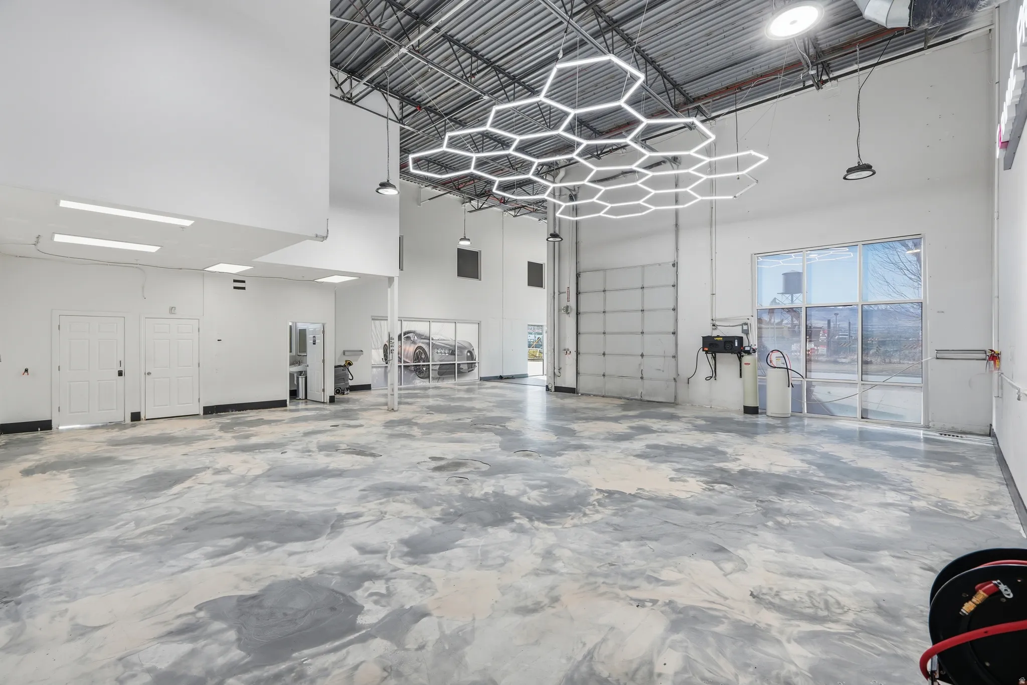 Miscellaneous room with a high ceiling and a garage