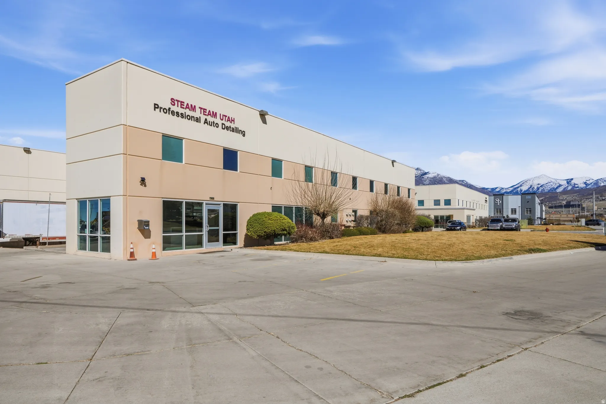 View of building exterior featuring uncovered parking and a mountain view