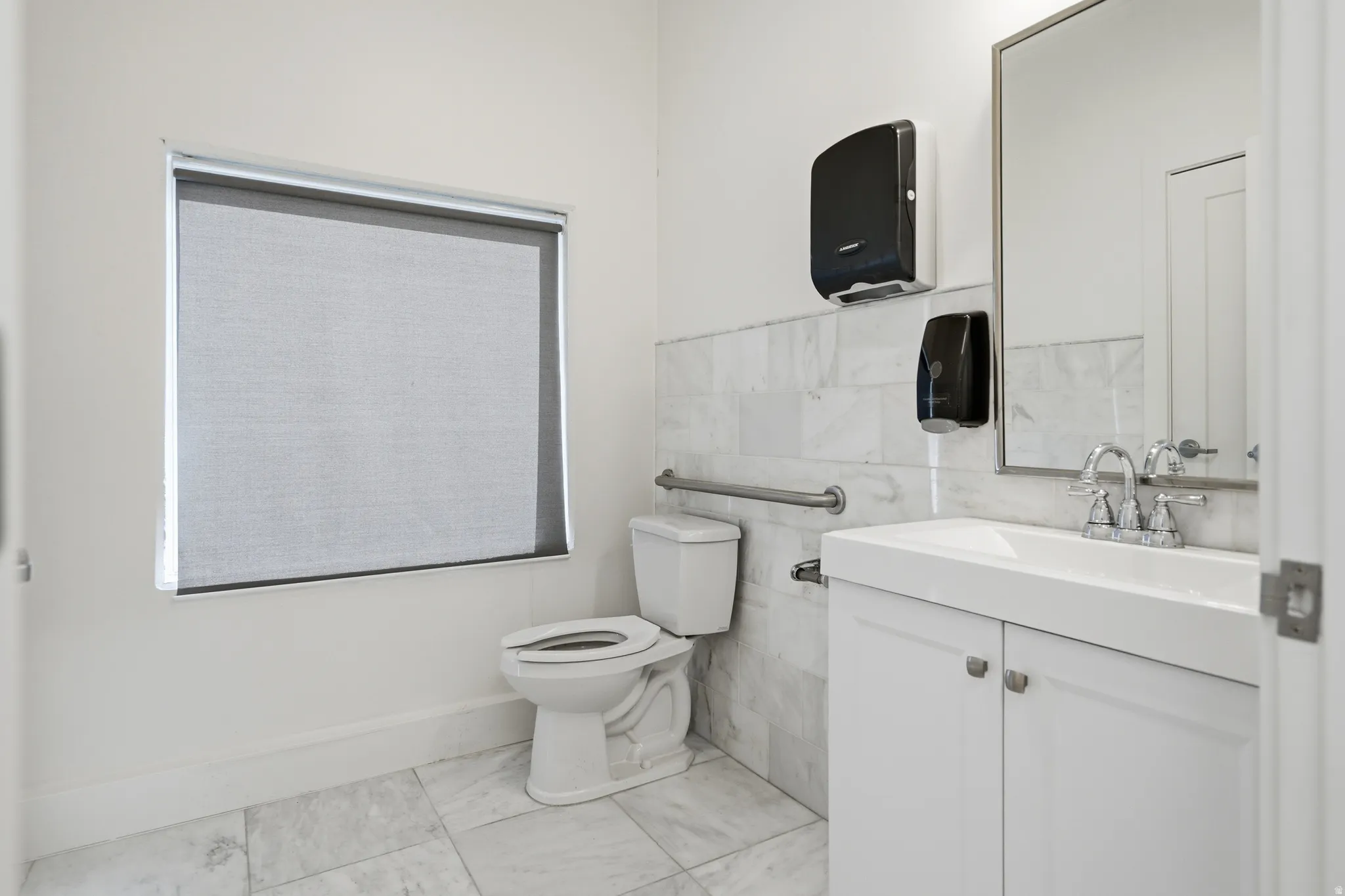Half bath with vanity and tile walls