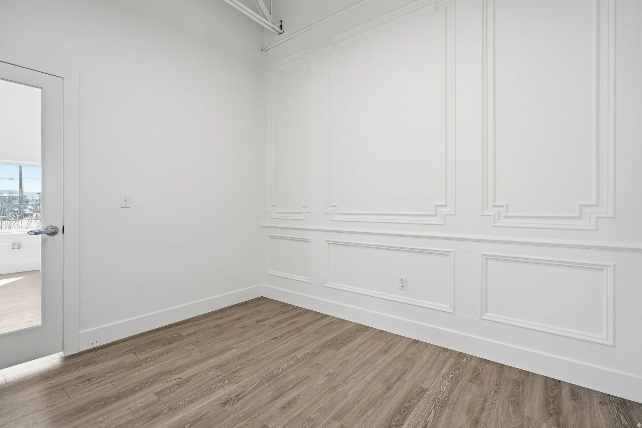 Walk in closet with wood finished floors