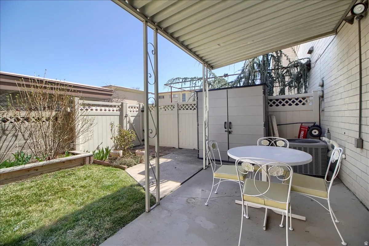 Fenced backyard with an outdoor dining area and a patio