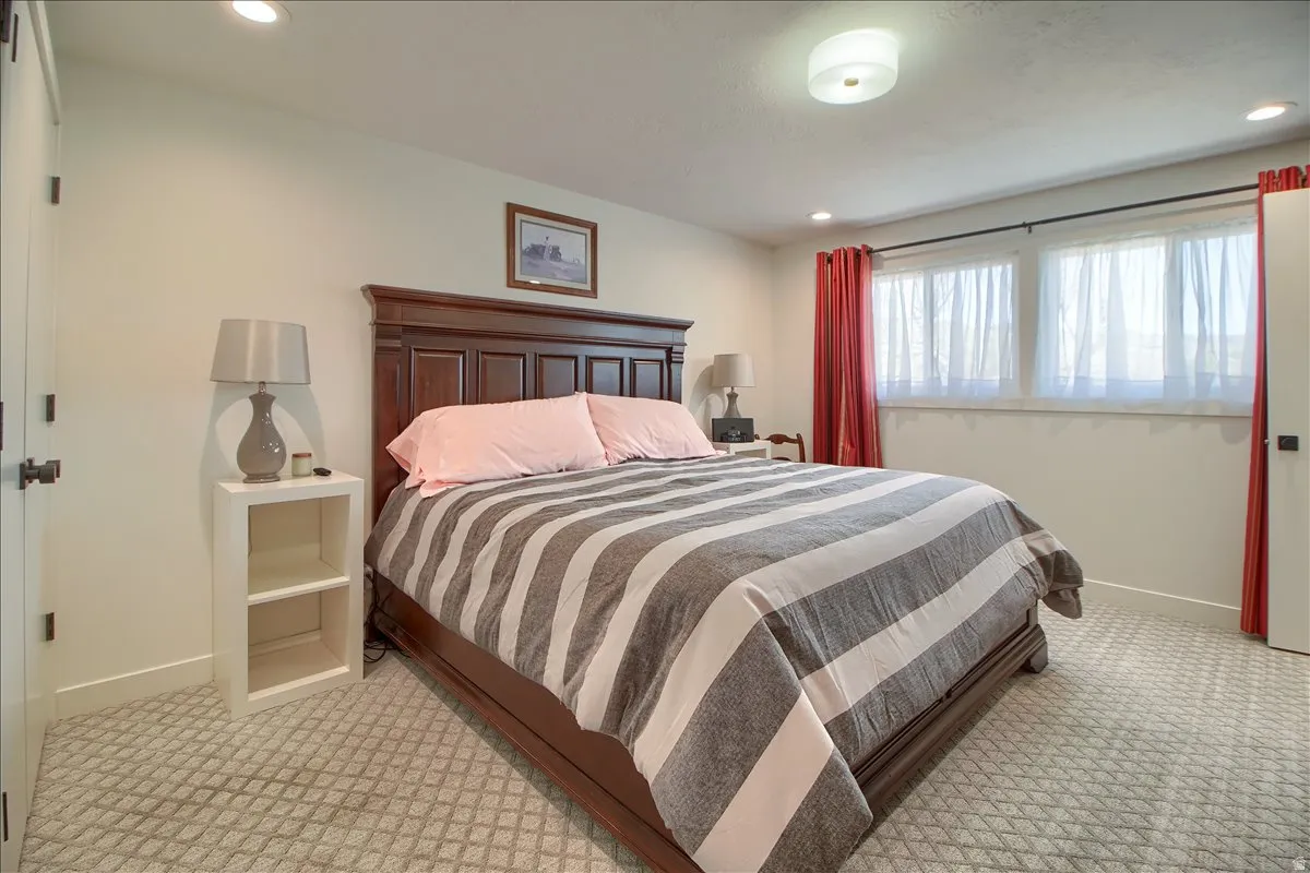 Main Bedroom featuring light colored carpet and recessed lighting