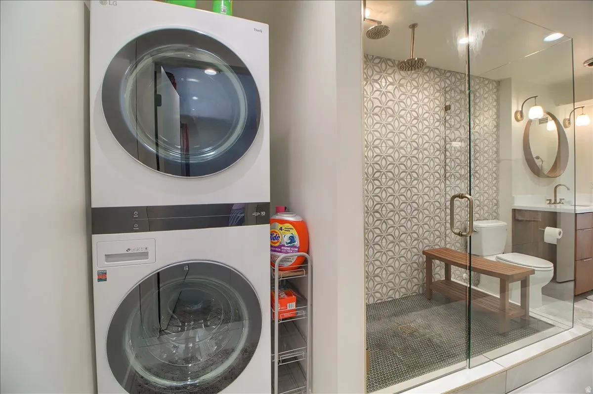 Laundry area off the main bedroom with a stacked washer and dryer