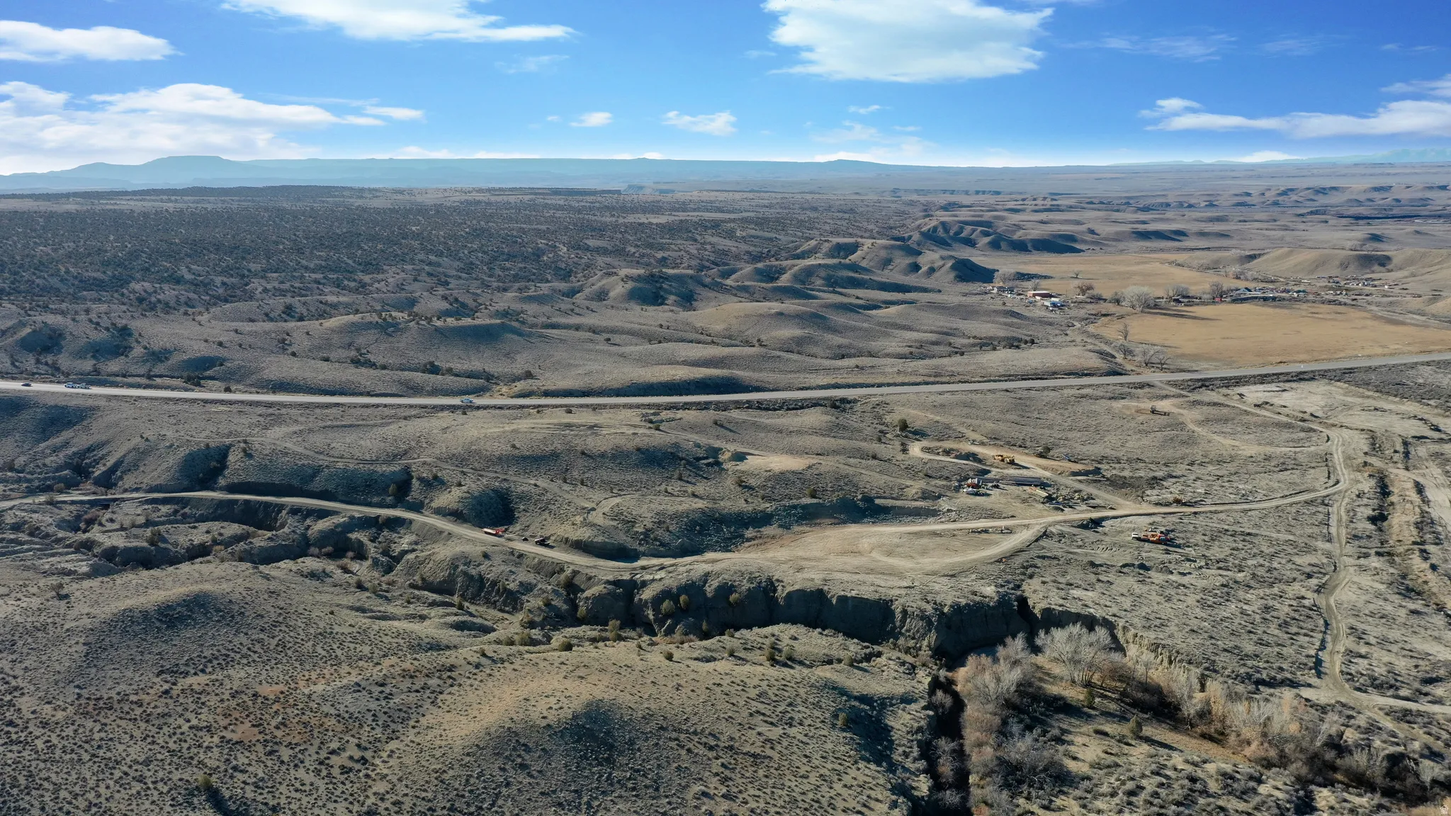 Aerial view of sparsely populated area featuring mountains and a desert landscape