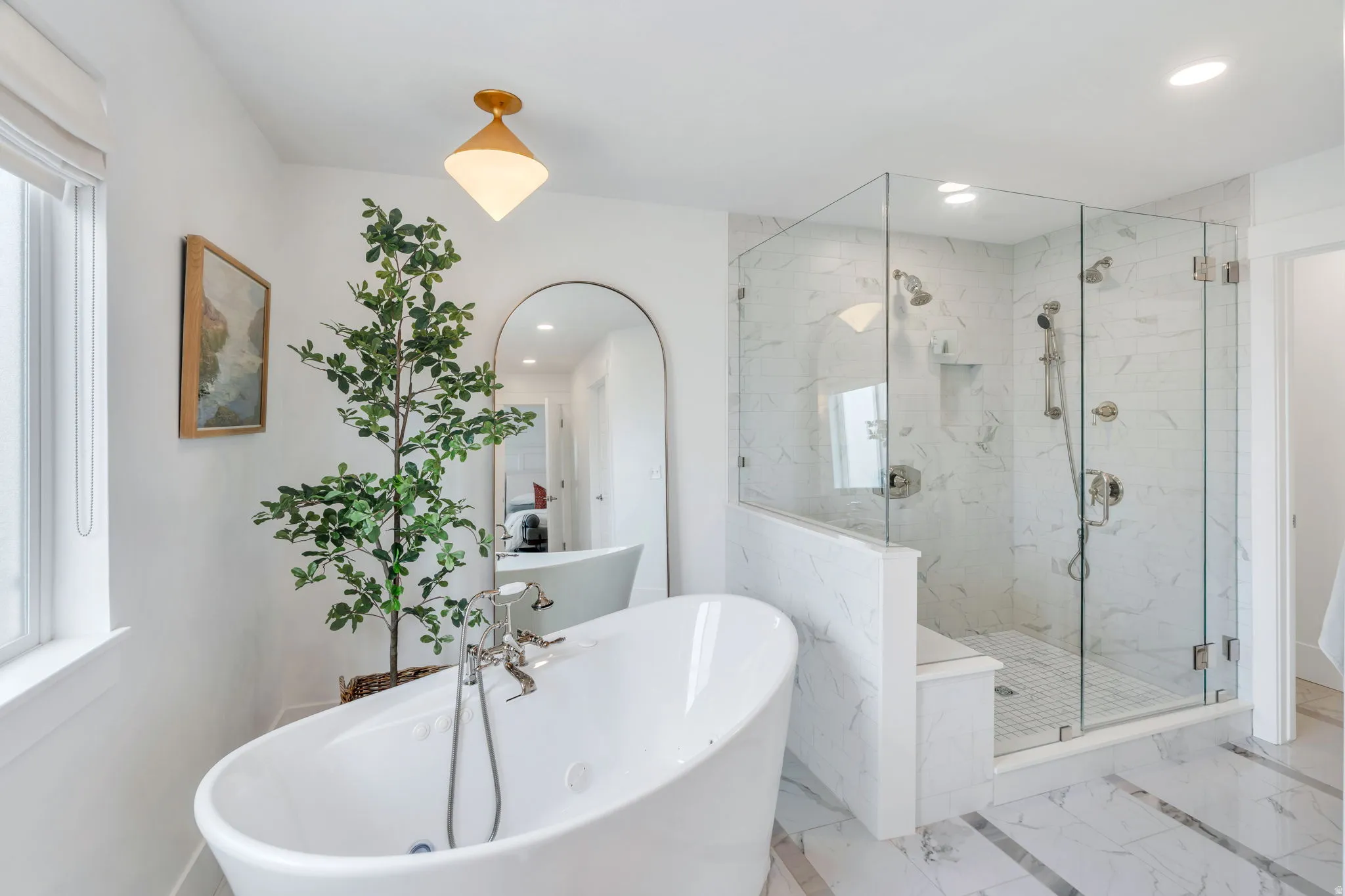 Full bath featuring recessed lighting, a freestanding tub, and a marble finish shower