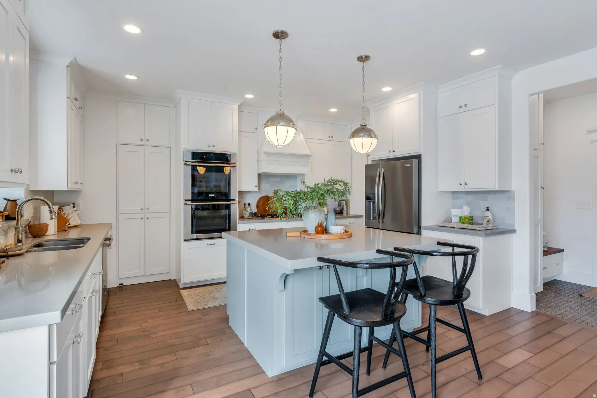 Kitchen featuring a breakfast bar, a center island, stainless steel appliances, and white cabinets