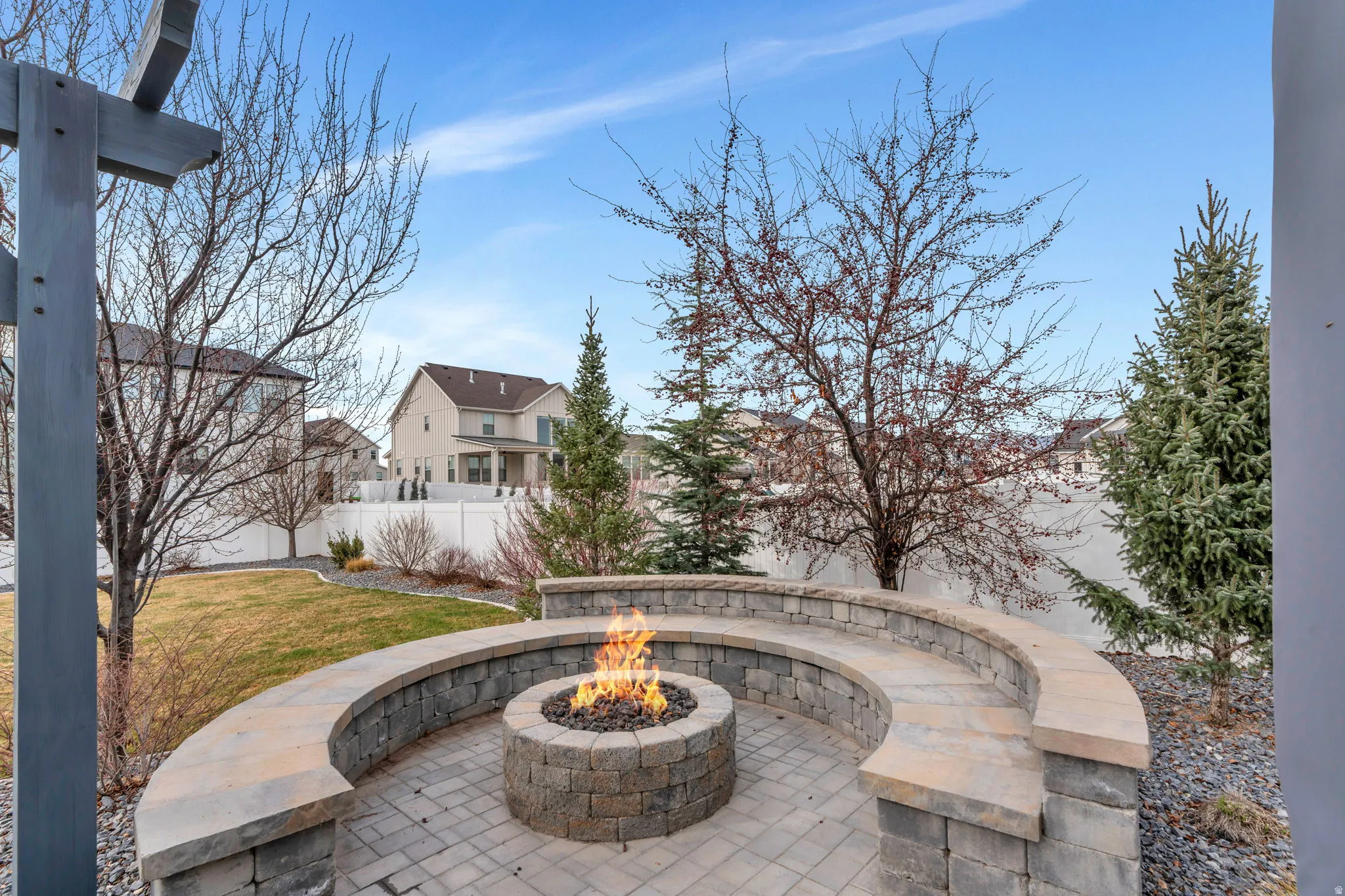 View of patio / terrace featuring an outdoor fire pit and a residential view