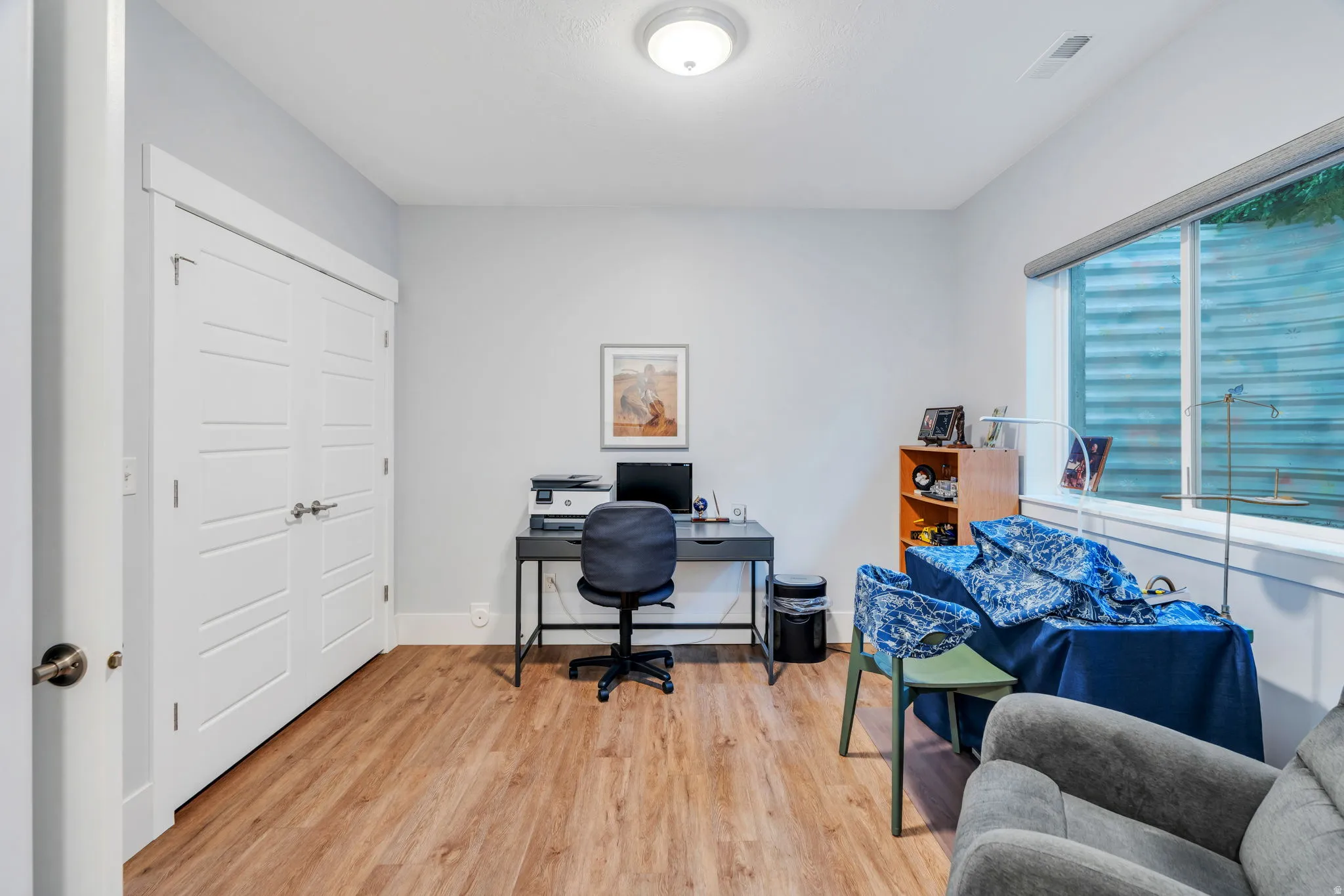 Office space featuring light wood-type flooring and baseboards