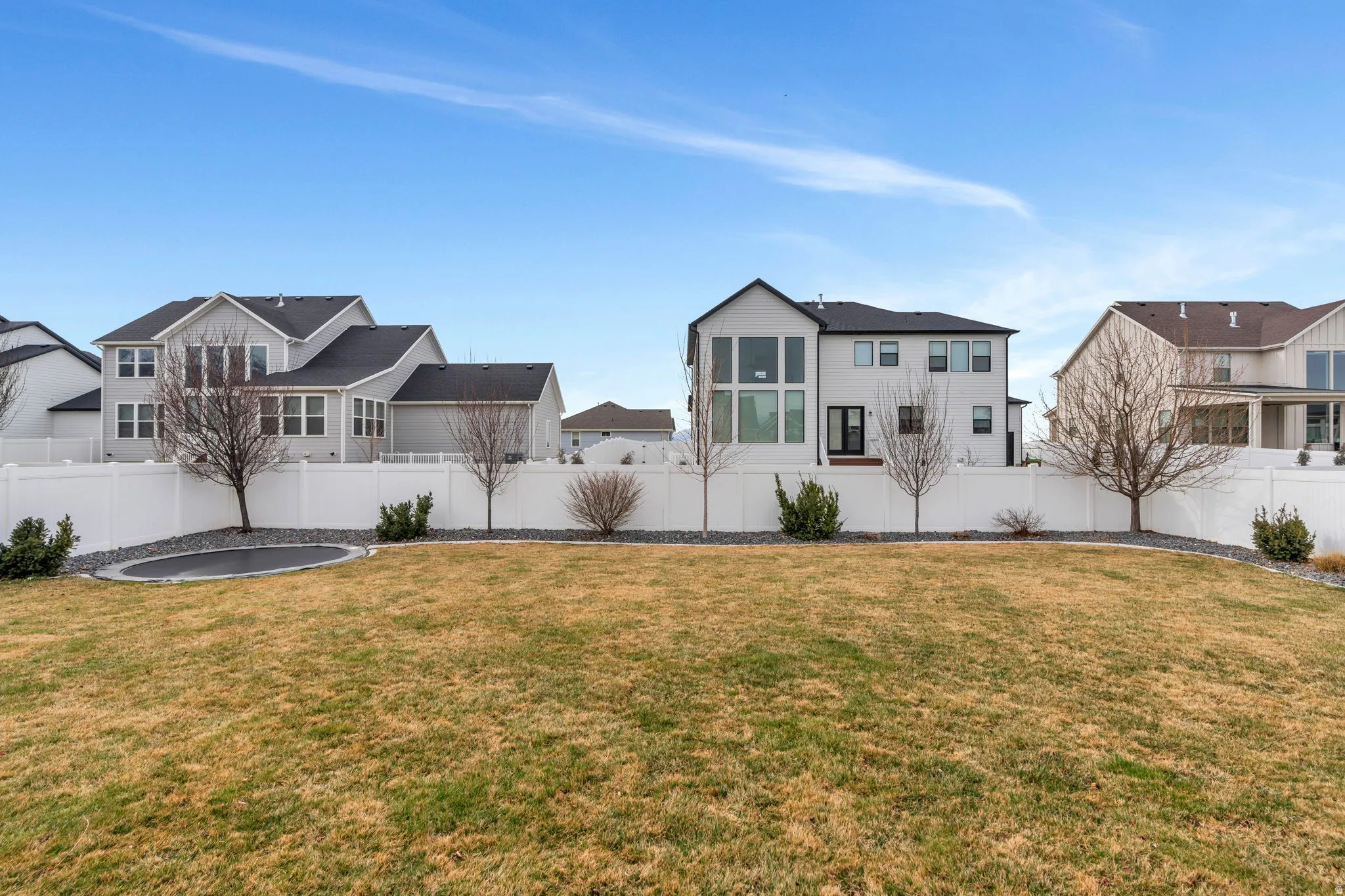 Fenced backyard featuring a residential view