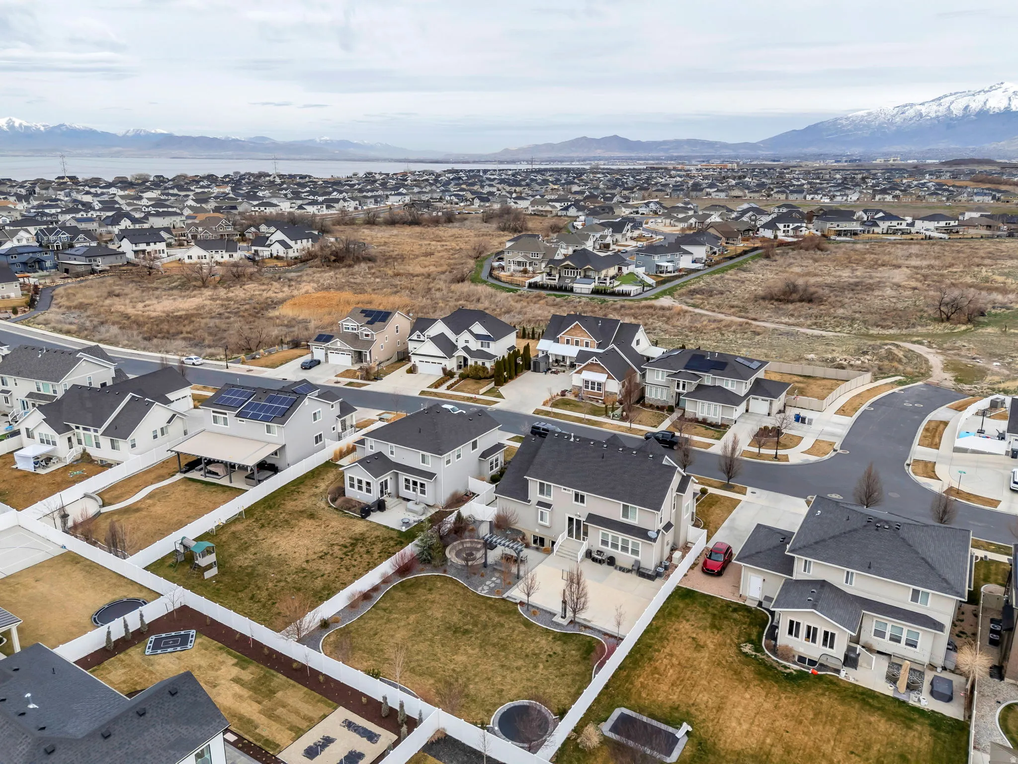 Aerial overview of property's location featuring nearby suburban area and a mountainous background