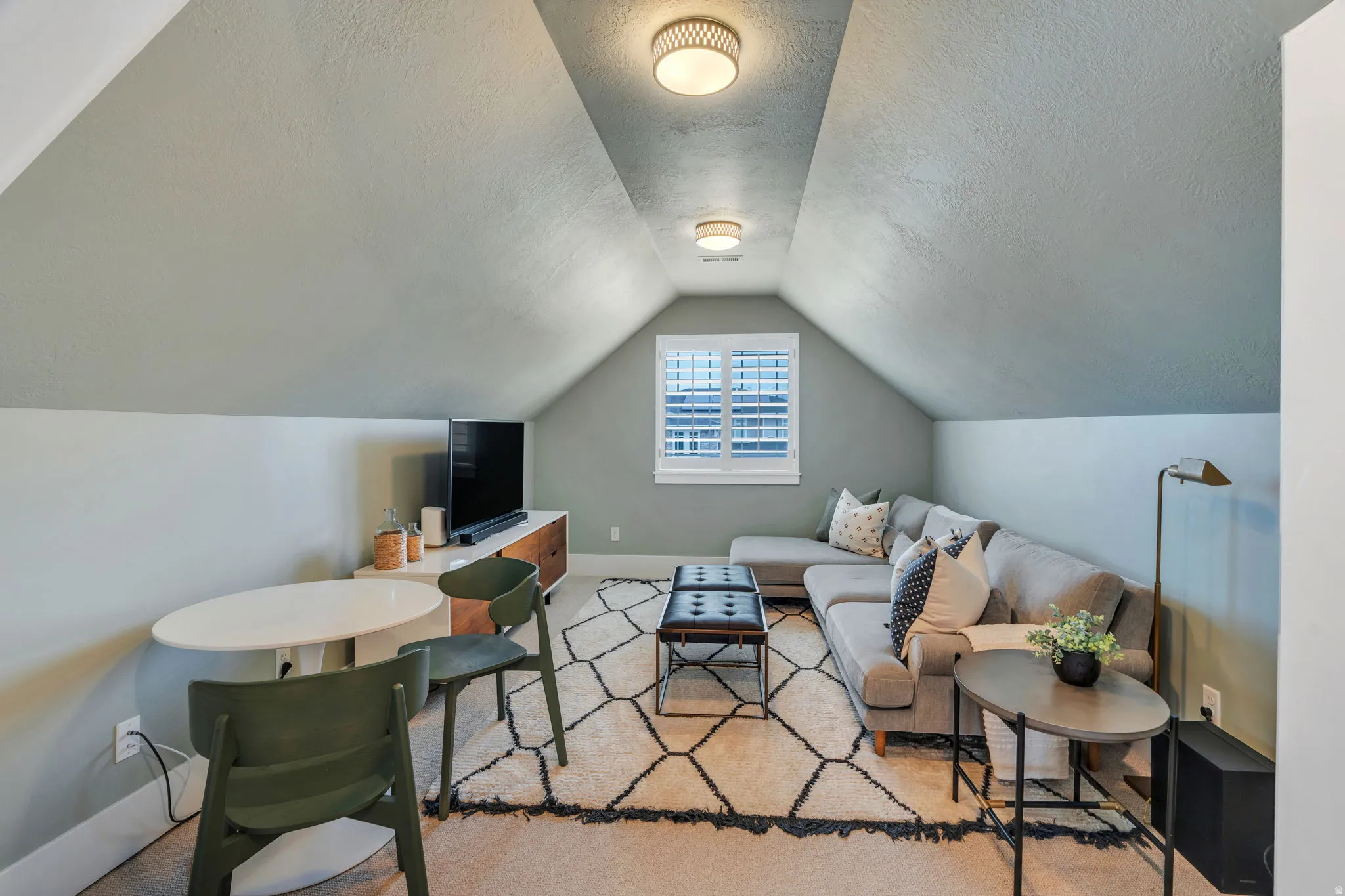 Living room featuring baseboards and a textured ceiling