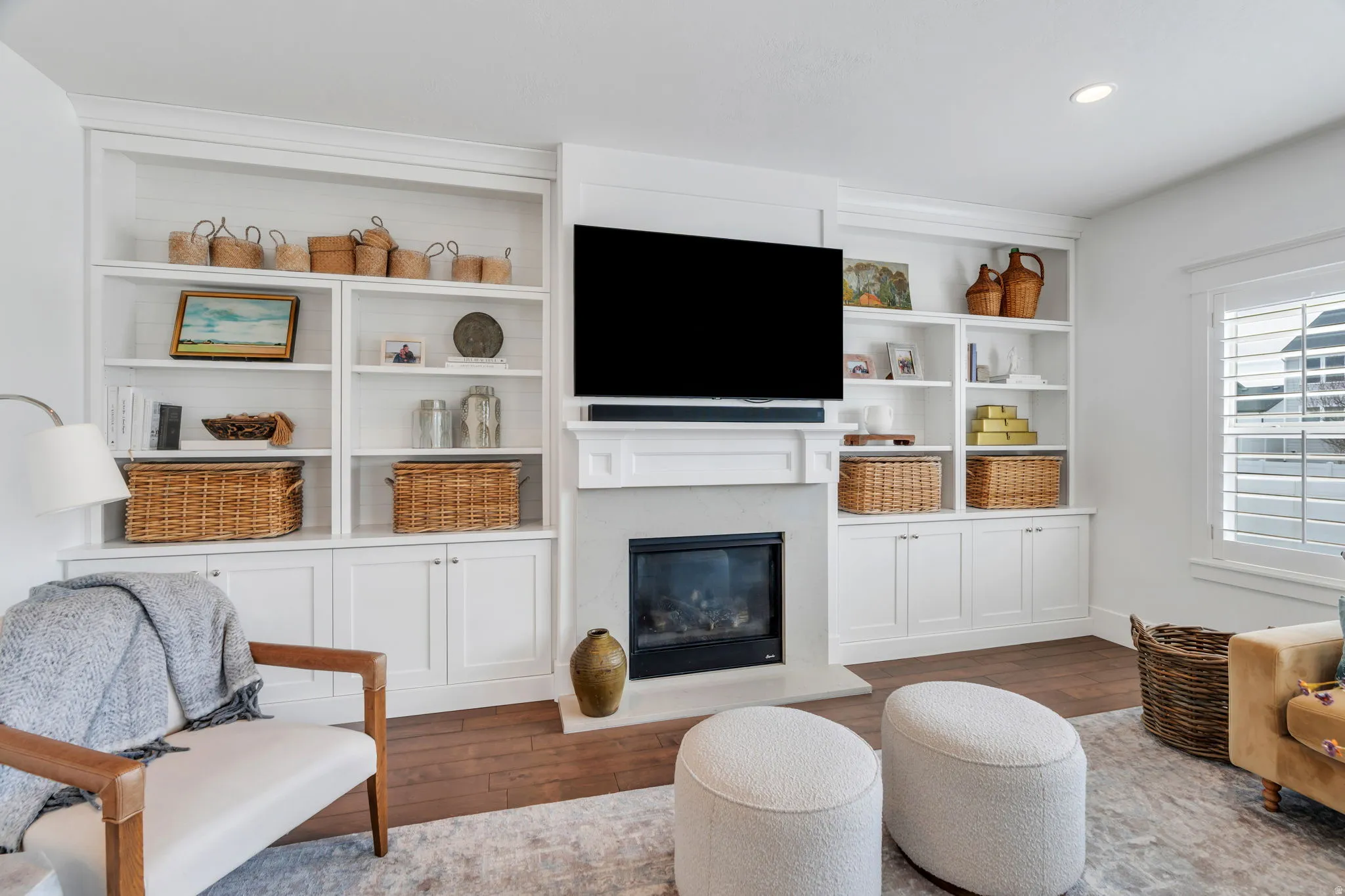Living area featuring a premium fireplace, wood finished floors, and recessed lighting