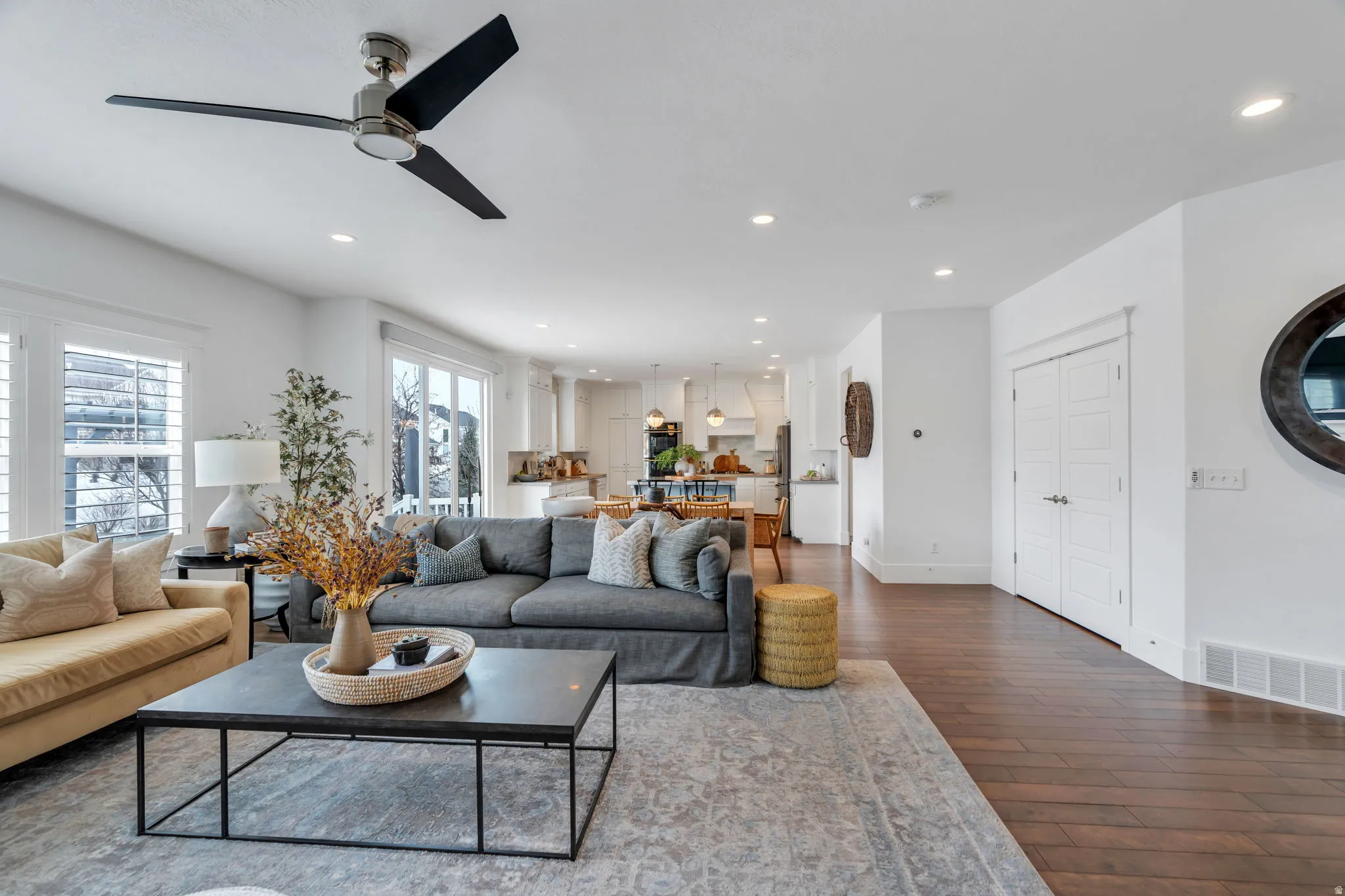 Living room featuring recessed lighting, dark wood-style flooring, and ceiling fan