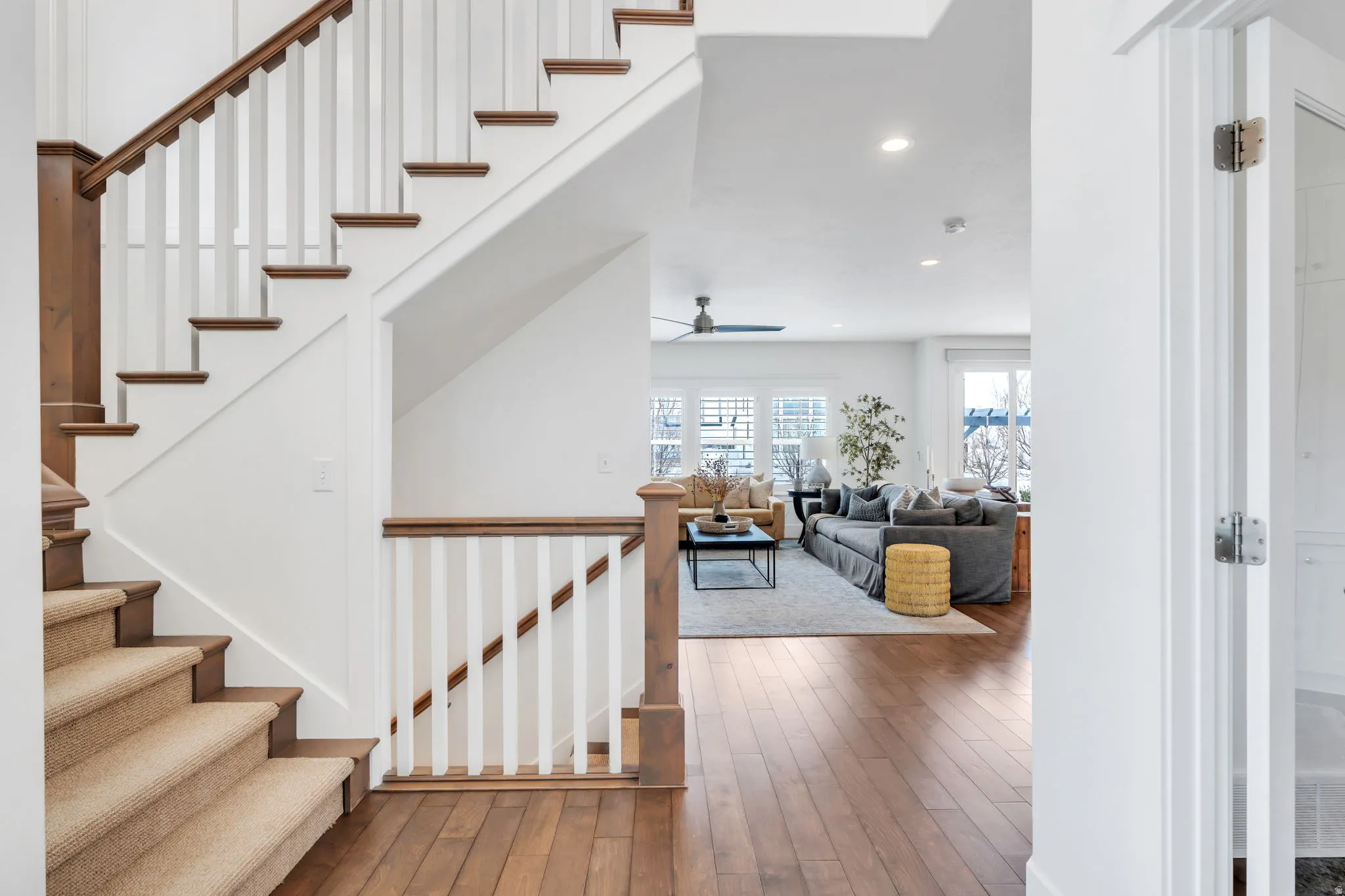 Staircase featuring hardwood / wood-style floors, recessed lighting, and a ceiling fan