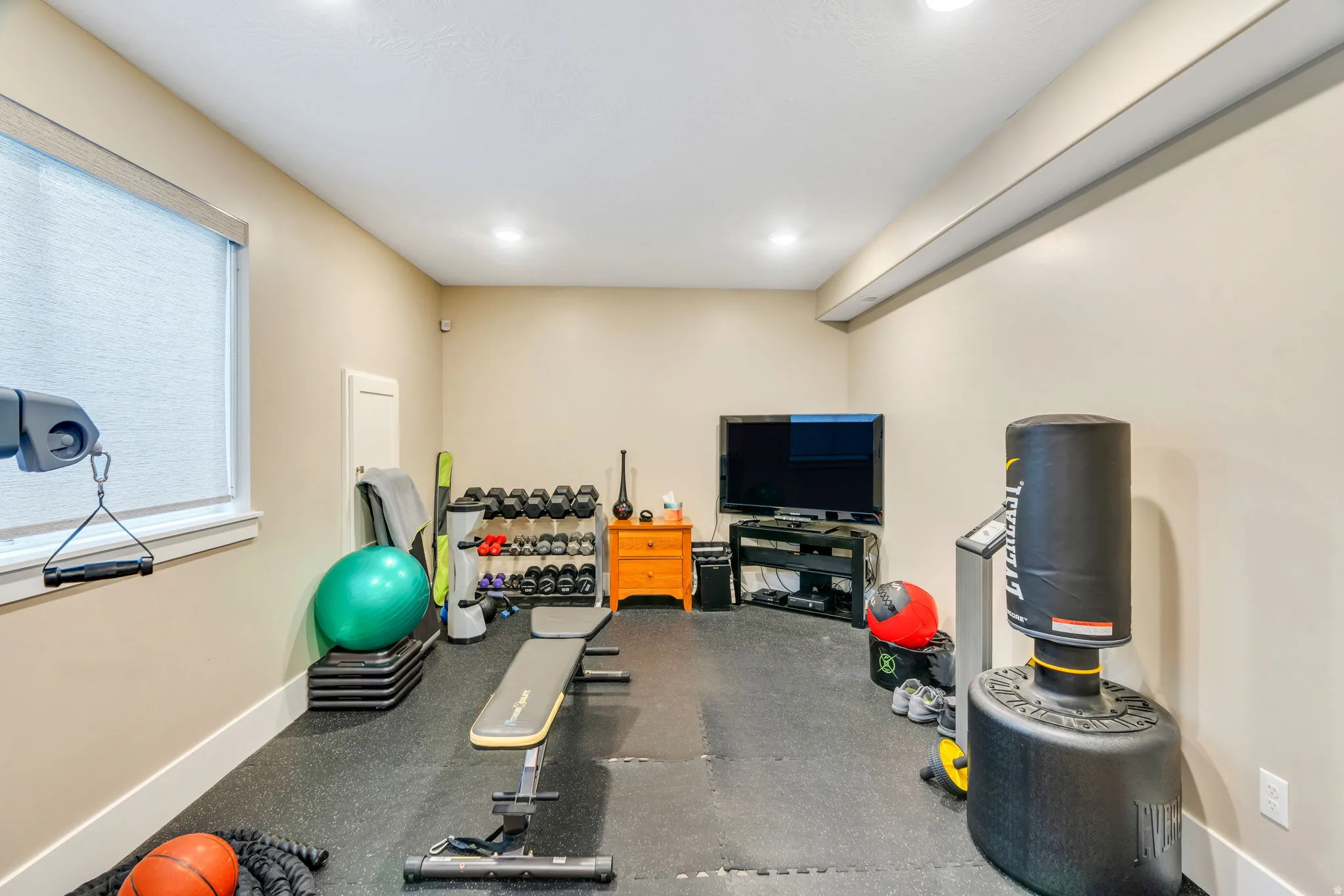 Workout area featuring rubber floors and baseboards