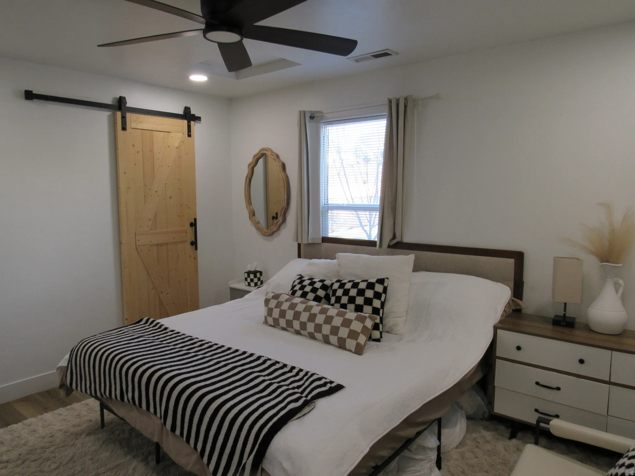 Bedroom #1 featuring a barn door, recessed lighting, a ceiling fan, and light wood-type flooring