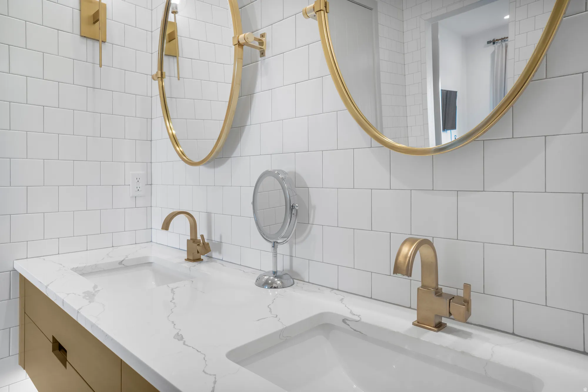 Full bath with double vanity, tile walls, and decorative backsplash