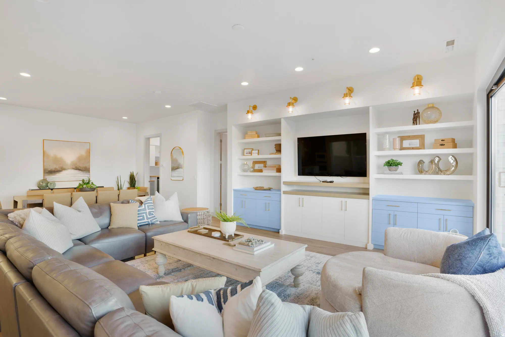 Living room featuring light wood finished floors, recessed lighting, and built in shelves