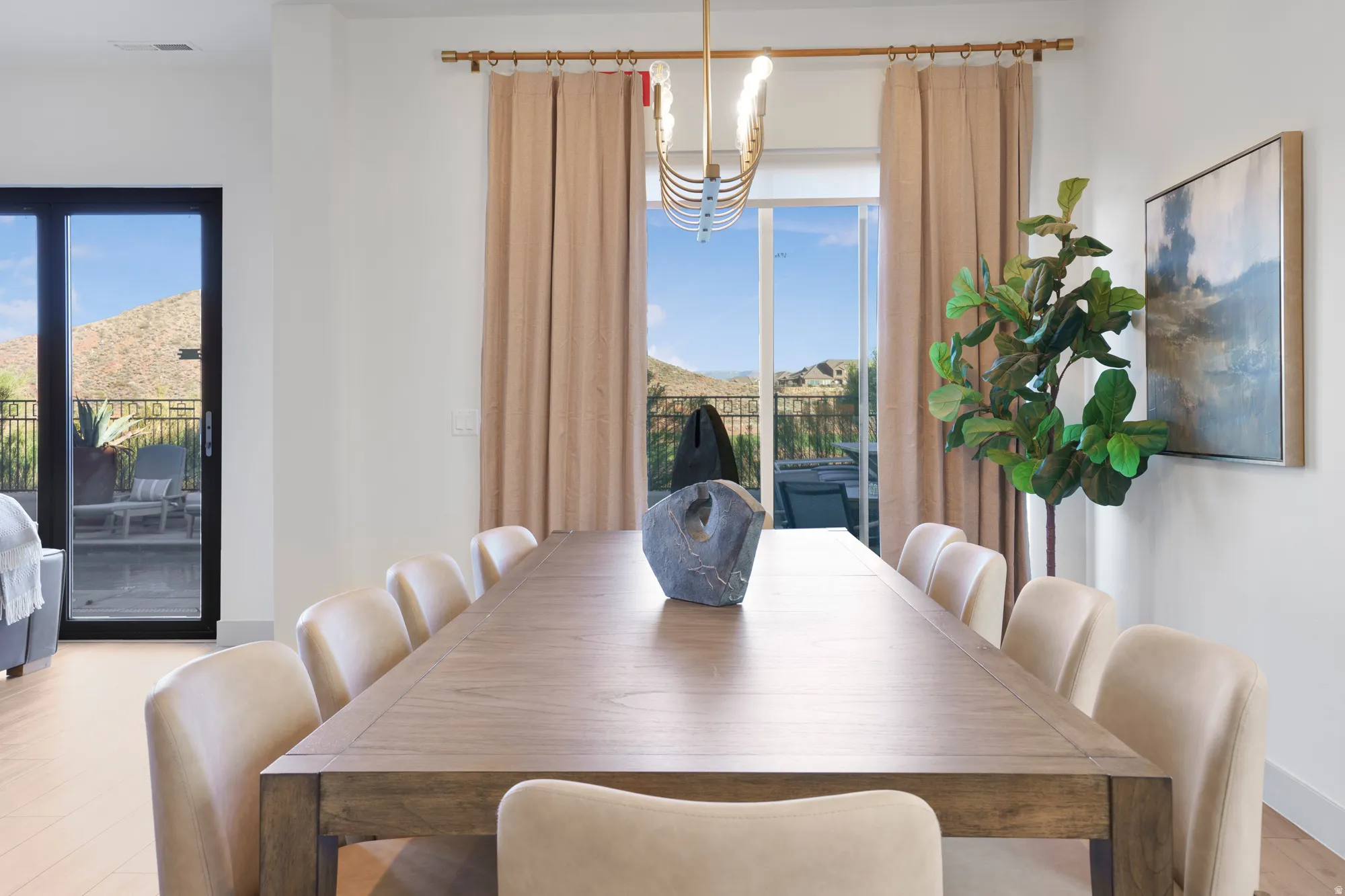 Dining room featuring a chandelier, a mountain view, and light wood-style floors