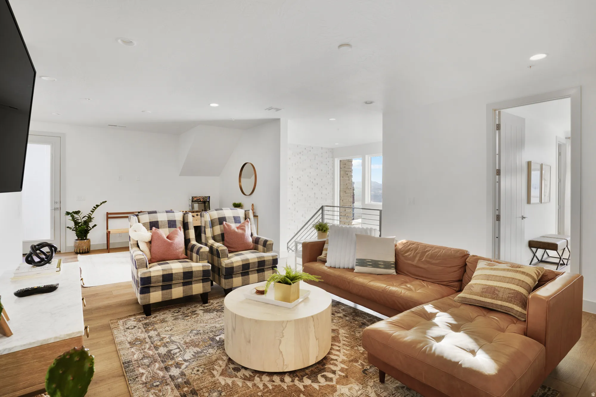 Living area featuring light wood finished floors and recessed lighting
