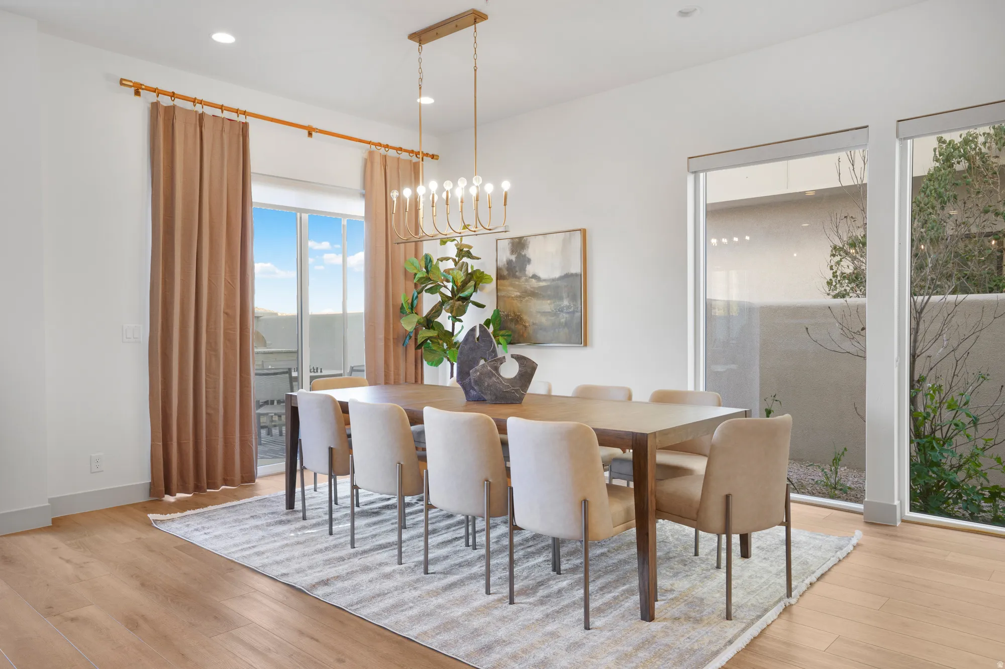 Dining space featuring suspended lighting, plenty of natural light, and light wood finished floors