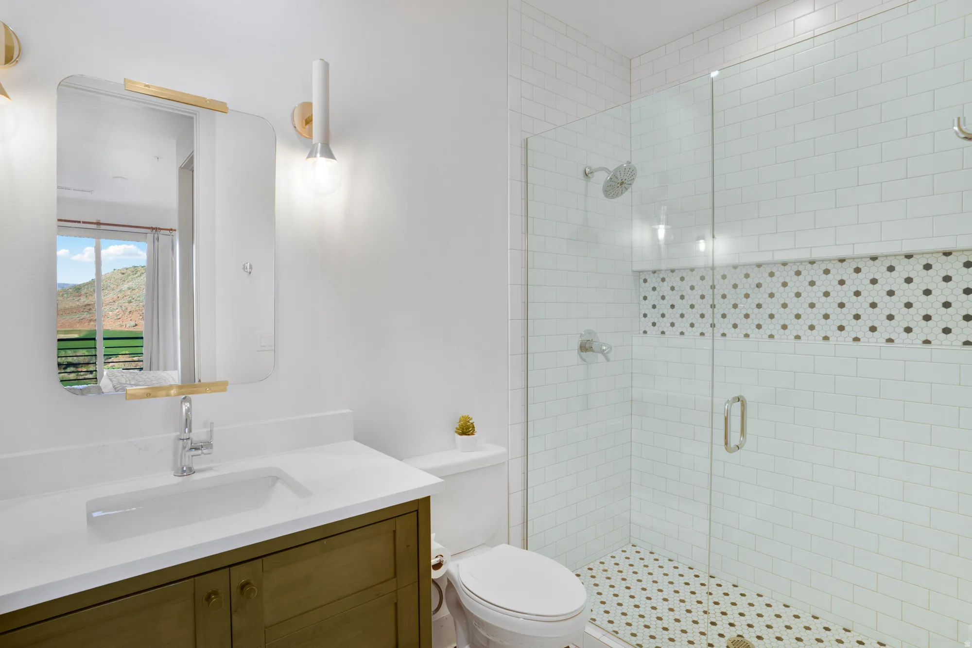 Bathroom featuring a stall shower and vanity