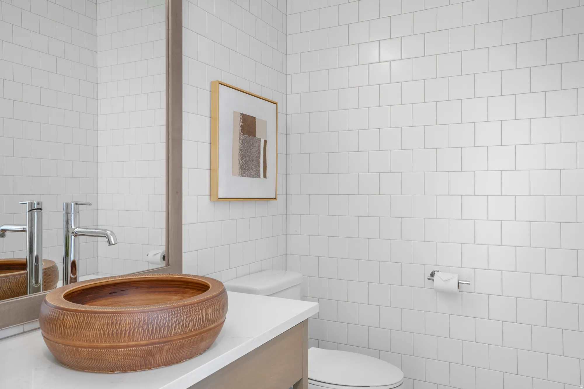 Bathroom featuring tile walls and vanity