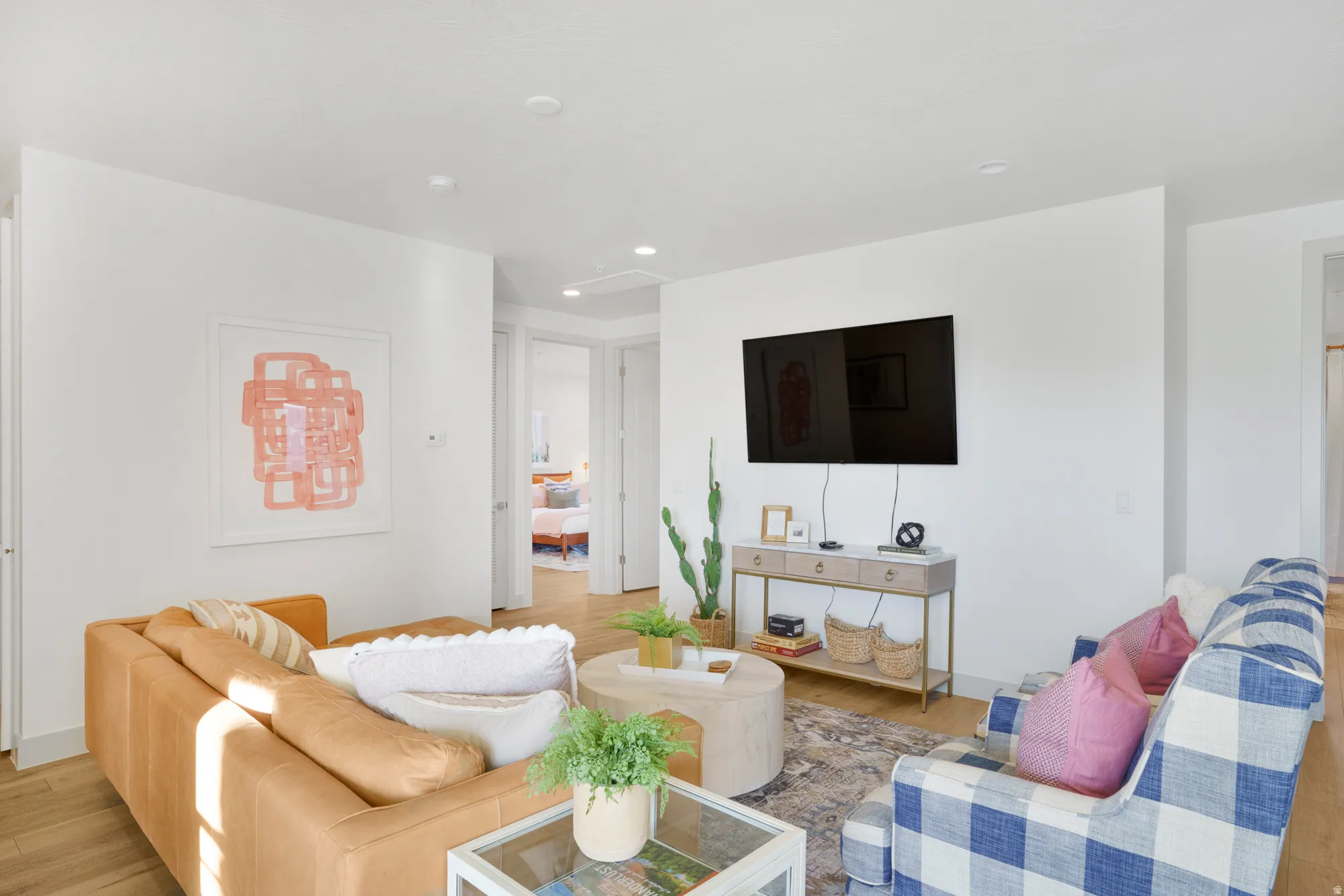 Living room with light wood-style floors and recessed lighting