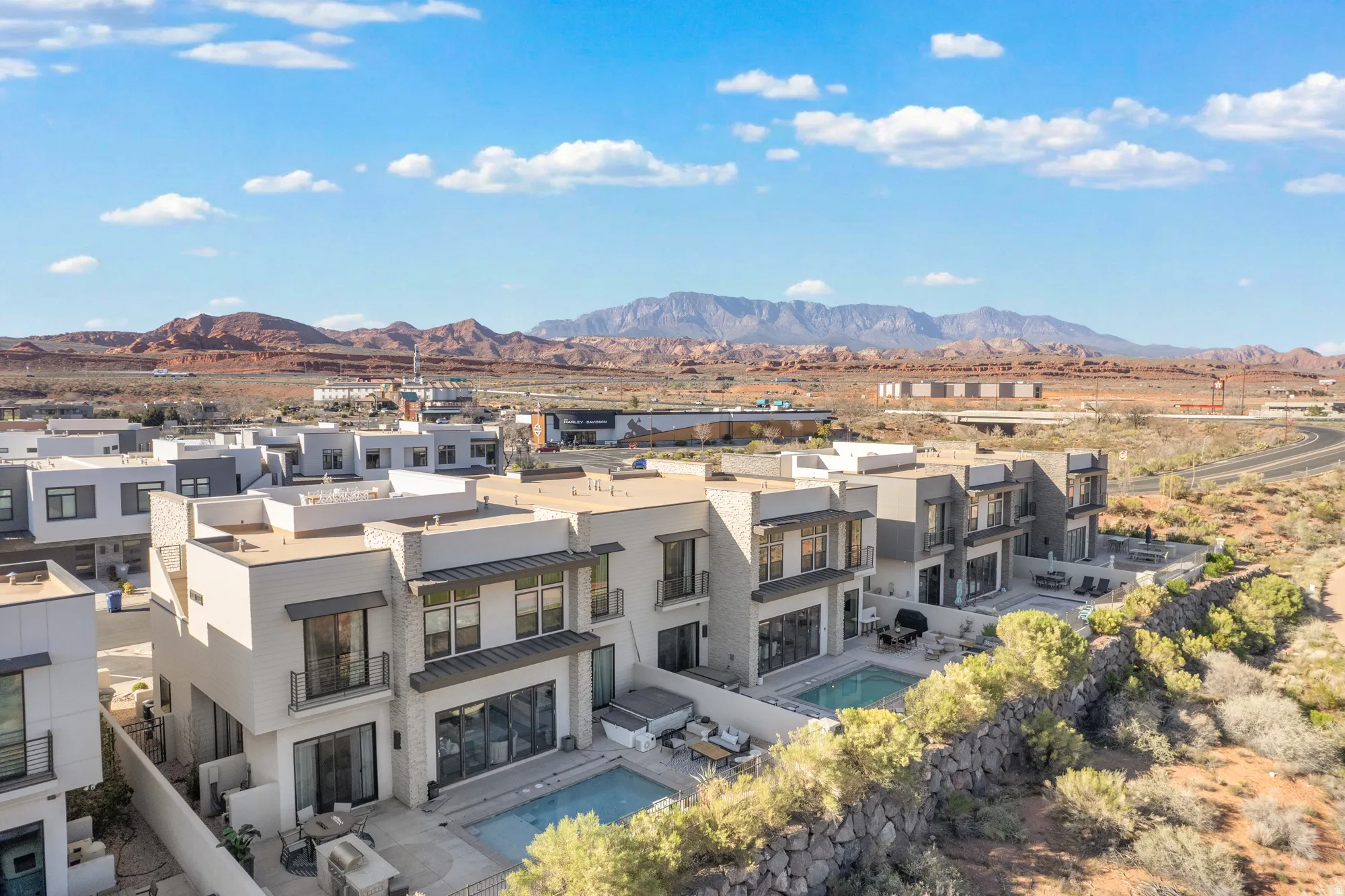 View of mountain backdrop featuring nearby suburban area
