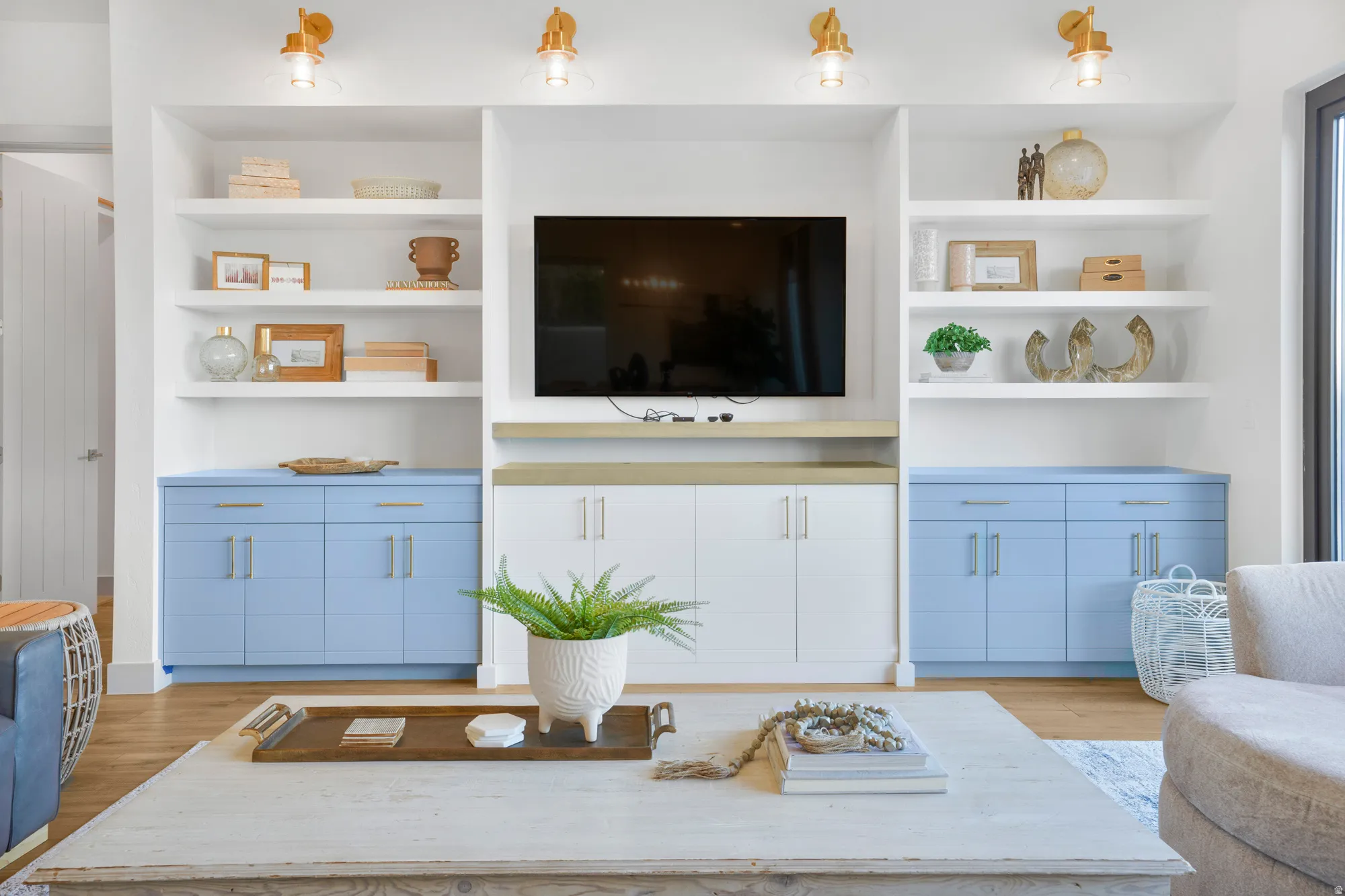 Living area with built in shelves and light wood-style floors