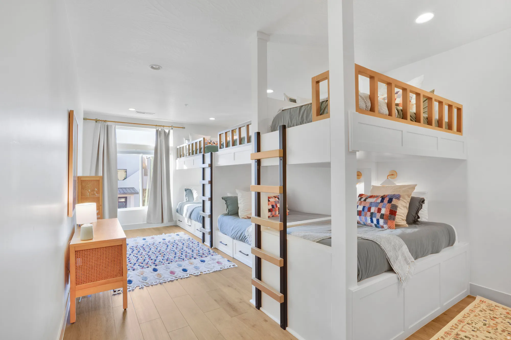 Bedroom with light wood finished floors and recessed lighting