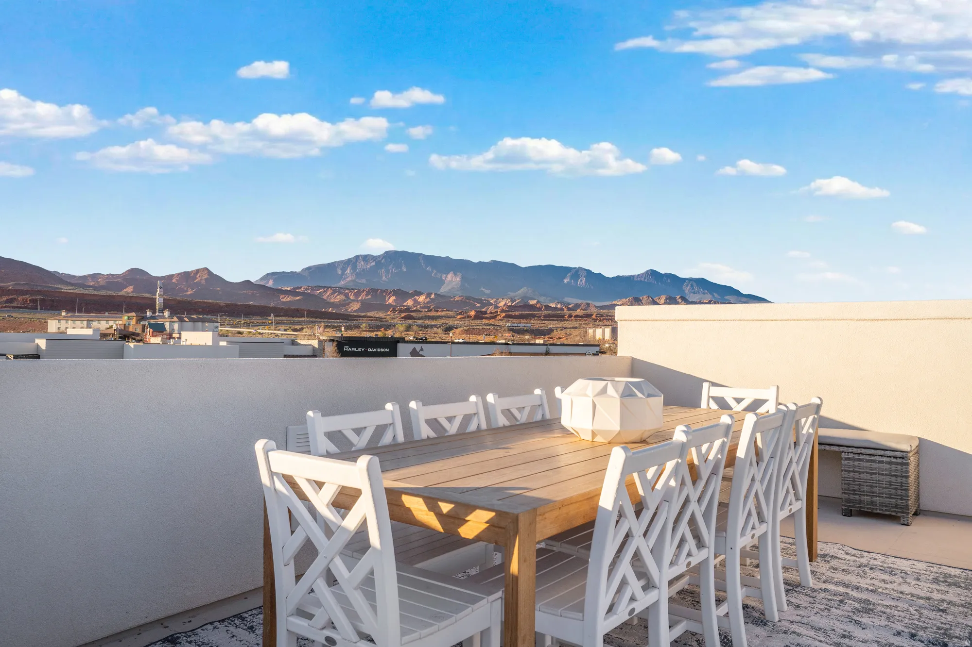 View of patio with outdoor dining space and a deck with mountain view