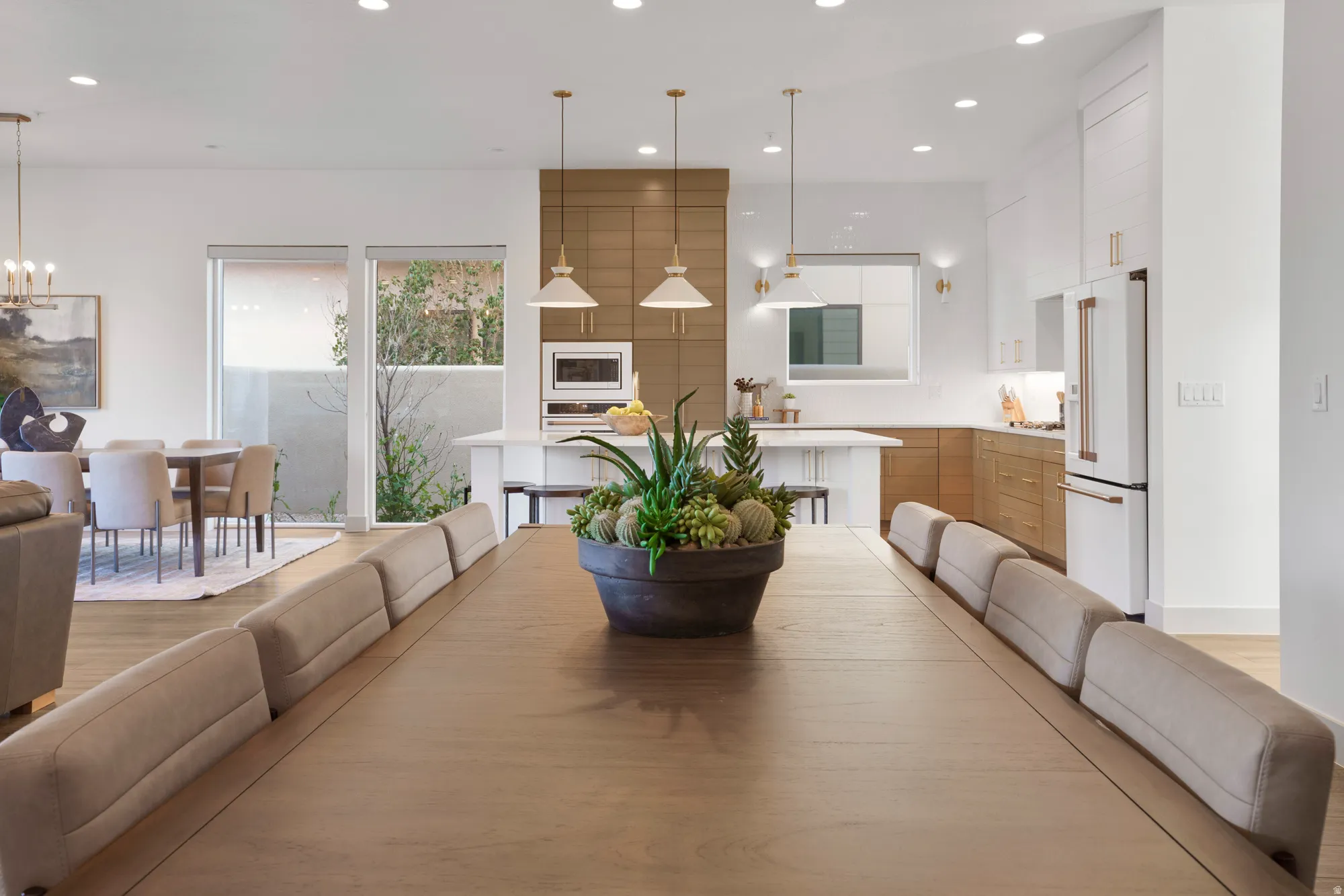 Dining area with hanging lights and light wood finished floors