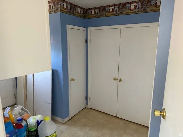 Unfurnished bedroom featuring light flooring and a closet