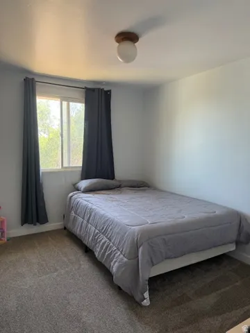 Carpeted bedroom with baseboards
