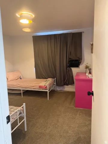 Bedroom with light carpet