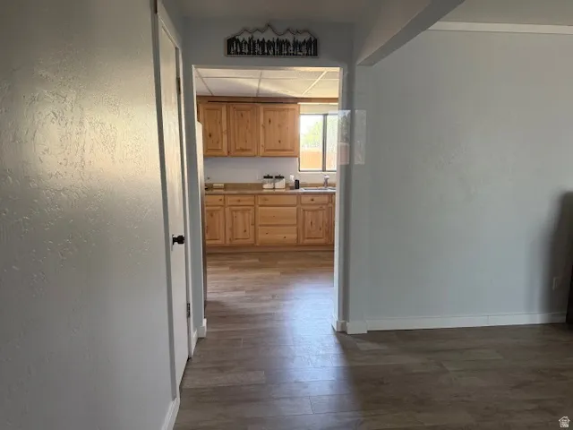 Hall with dark wood-style floors and a textured wall