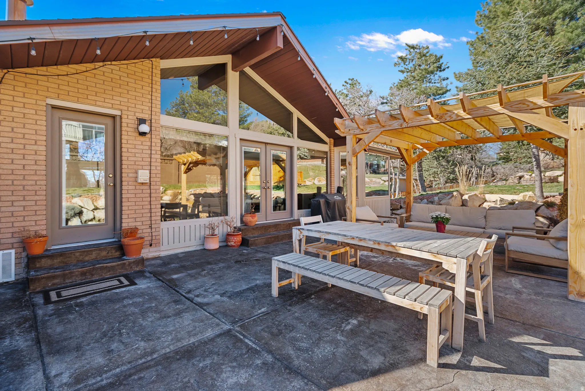 View of patio / terrace featuring a pergola, french doors, an outdoor living / dining area, and entry steps