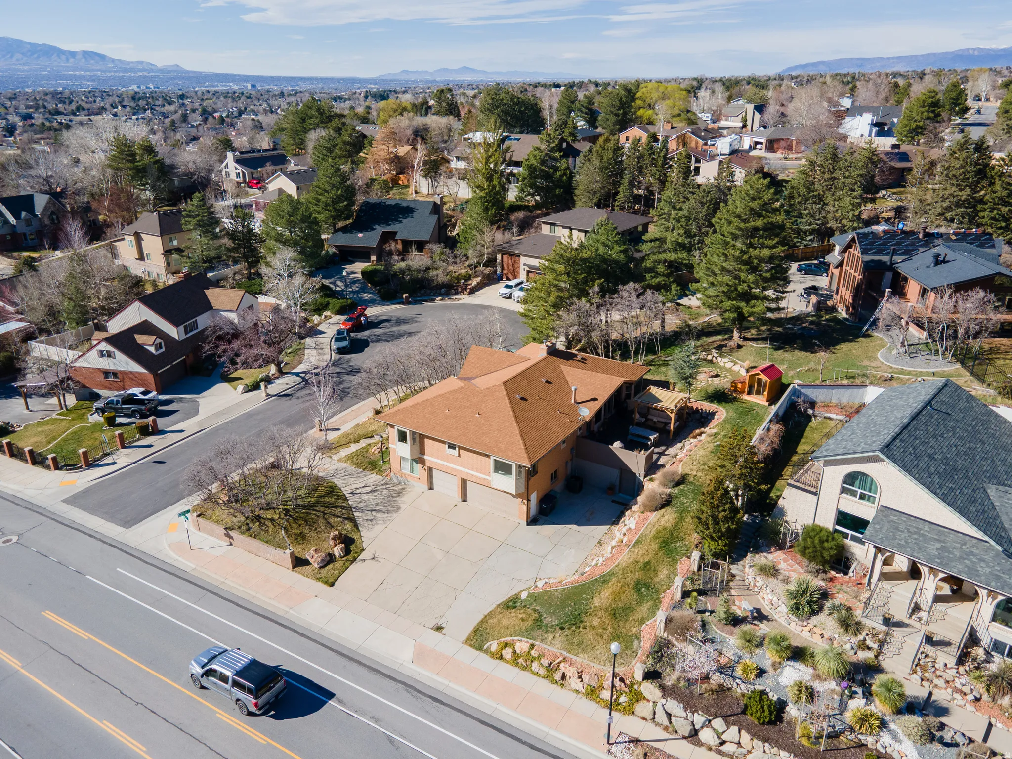 Aerial perspective of suburban area featuring a mountain backdrop