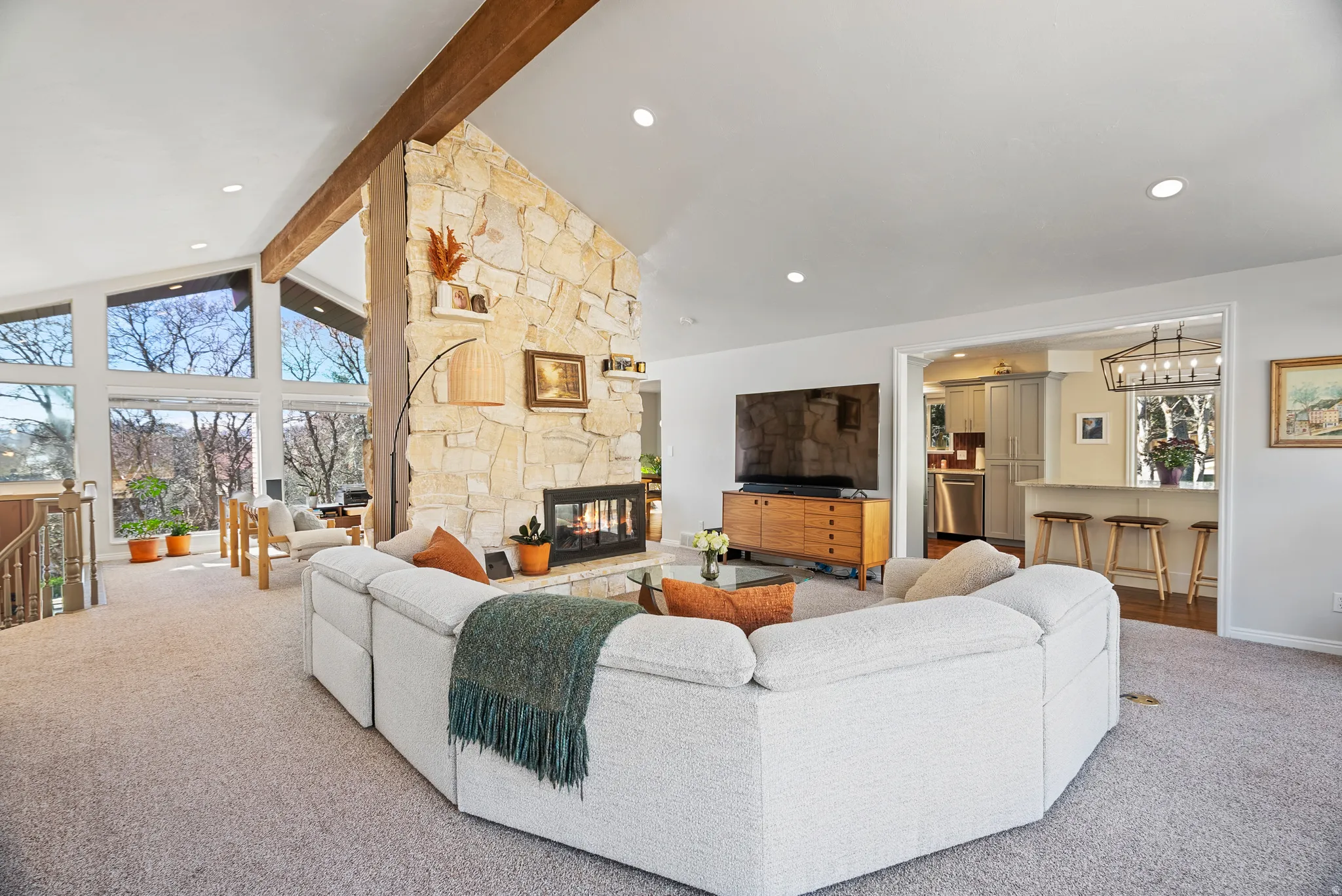 Carpeted living area featuring a fireplace and recessed lighting