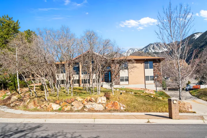 View of front of house with brick siding and a mountain view