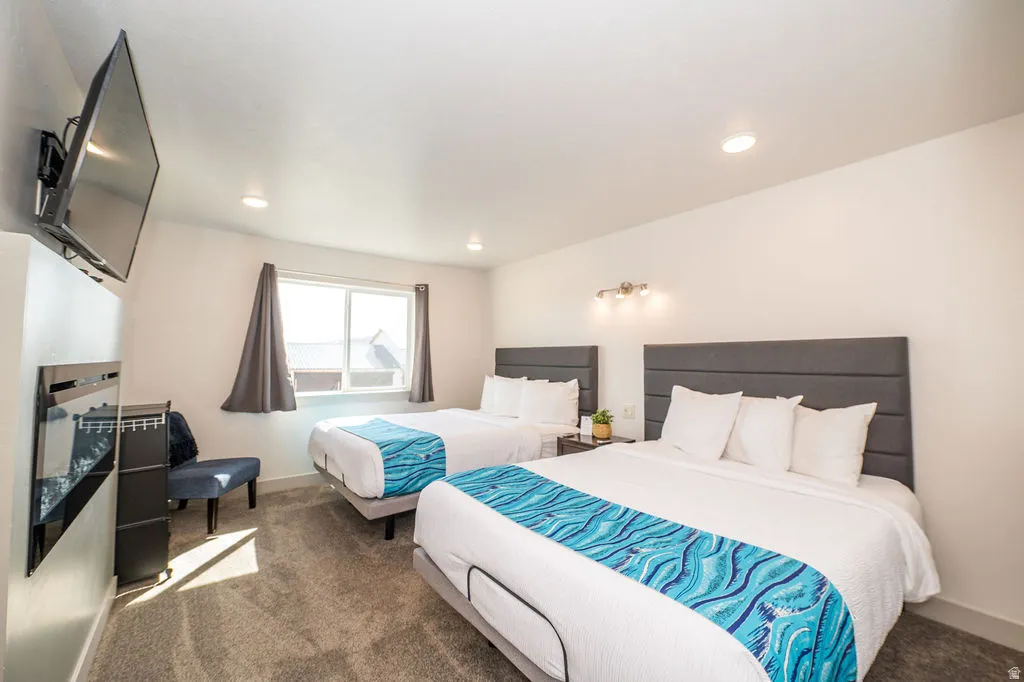 Bedroom featuring carpet floors, a fireplace, and recessed lighting