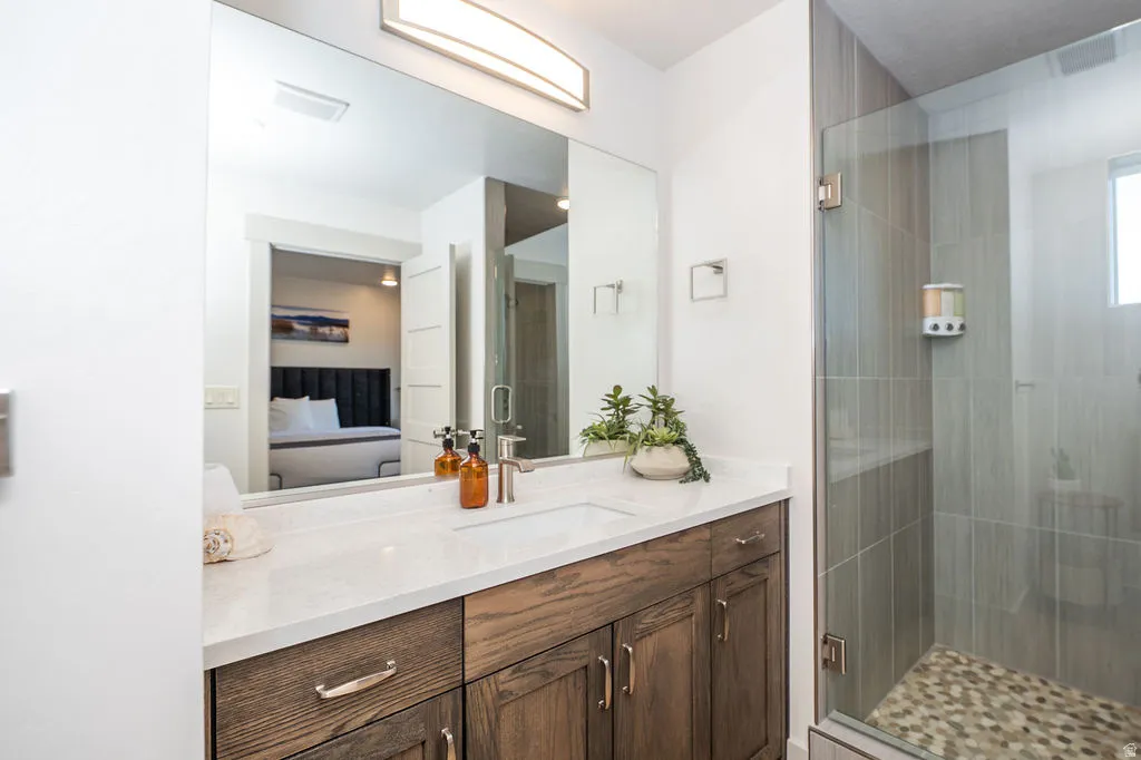 Ensuite bathroom with vanity and a shower stall