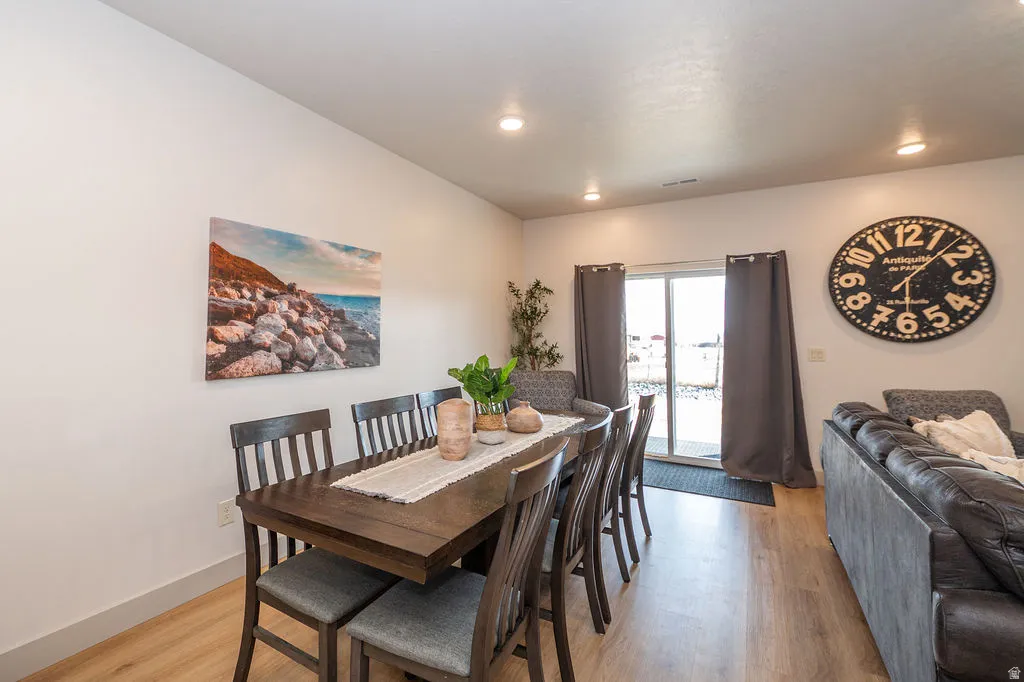 Dining area featuring light wood-style floors and recessed lighting