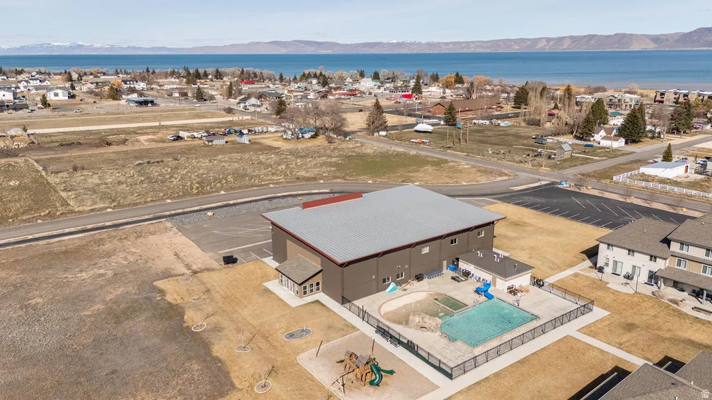 View of property location featuring a water and mountain view and nearby suburban area